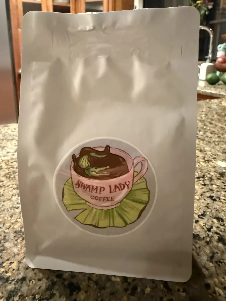 A bag of Swamp Lady Coffee standing on a granite kitchen counter